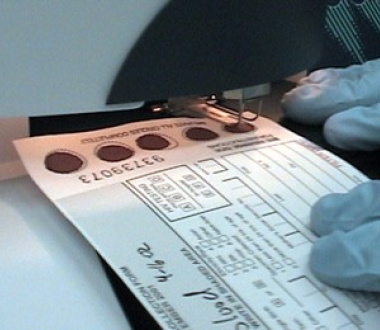 Taking a punch from a card containing dried blood spots